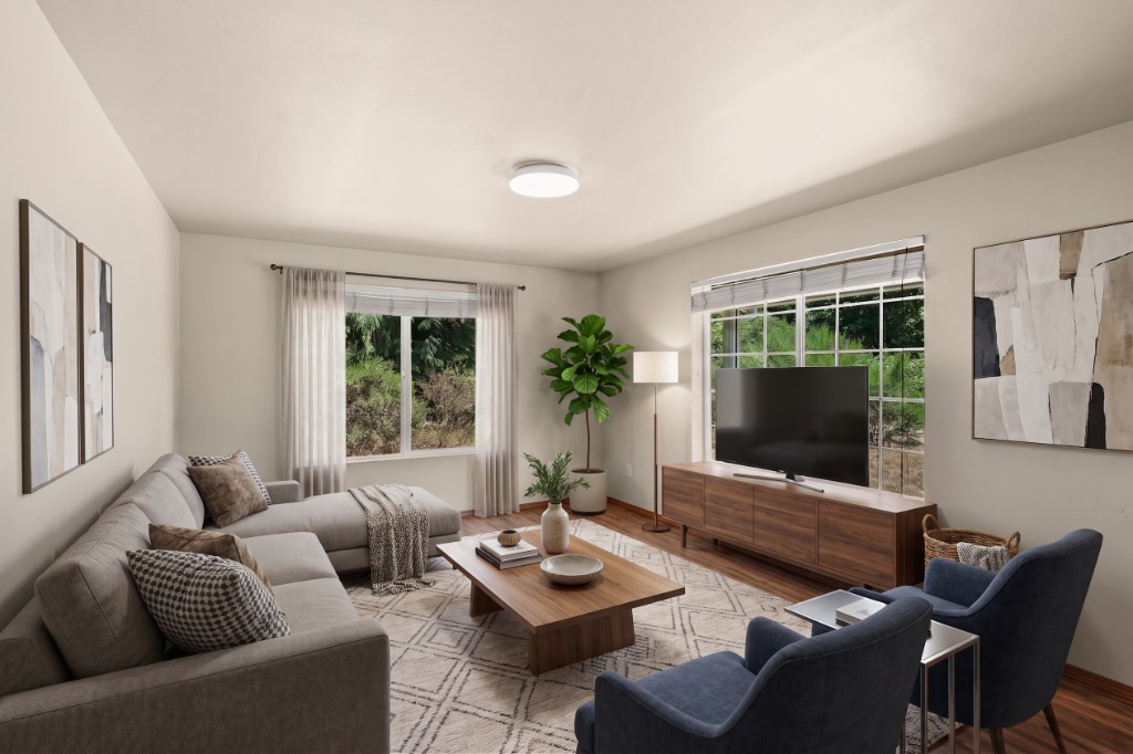 Virtually staged modern living room with sectional sofa and natural light